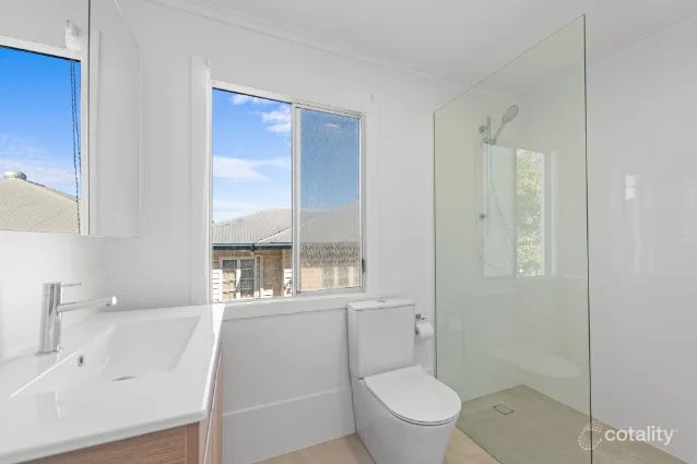 Mitchelton bathroom after renovation: frameless shower and white vanity